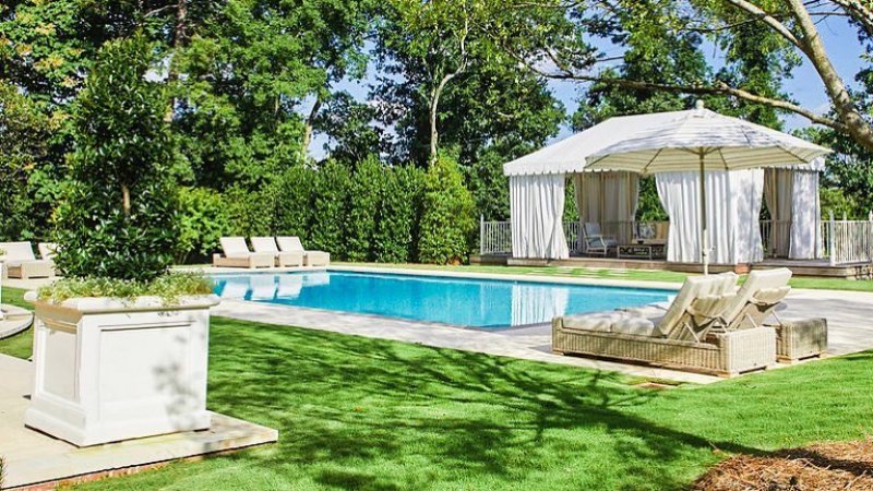 Pool in backyard with patio furniture